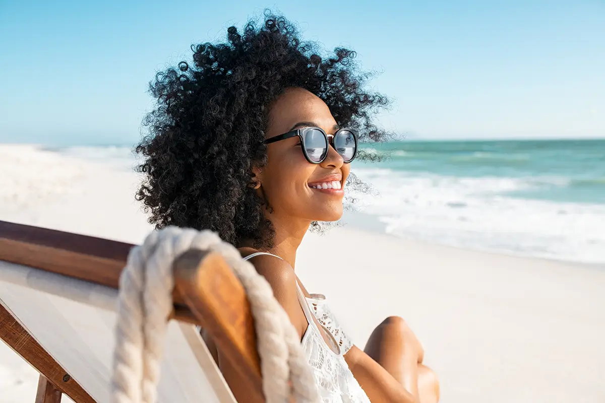 woman sitting in the sun wearing sunglasses