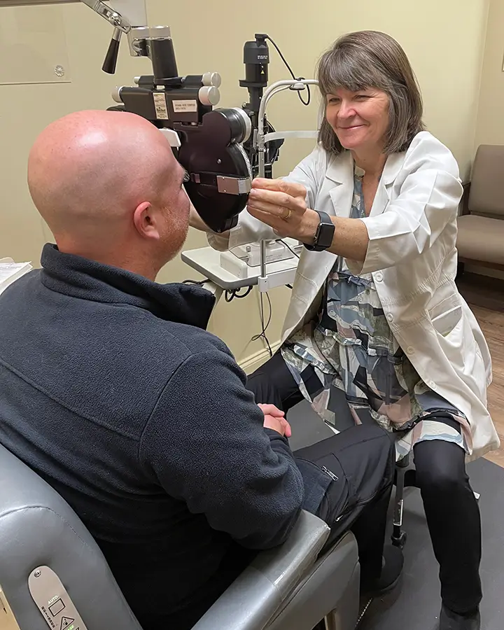 silvia mende giving an eye exam to a patient