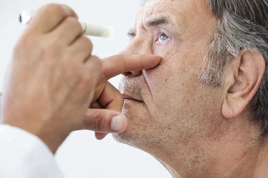 elderly man being looked at by an ophthalmologist